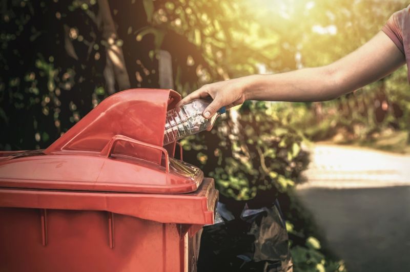 steel-bin-throwing-away-trash-at-campsite-min