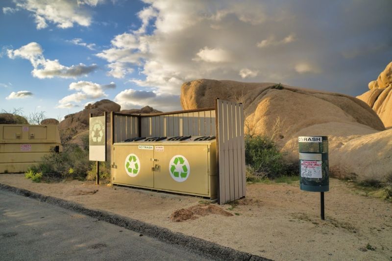 steel-bin-throwing-recycling-station-at-campsite-min