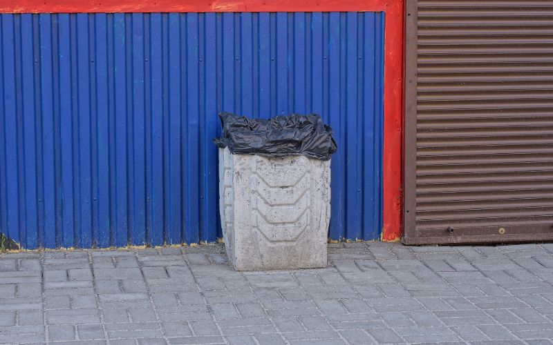 concrete-bins-one-gray-concrete-bin-stands-on-the-sidewalk-outside-min