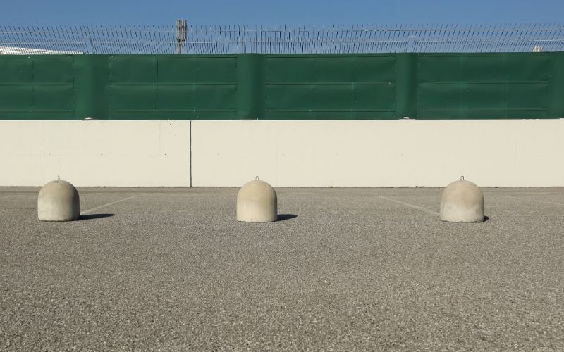 concrete-bollards-concrete-road-bollard-in-front-of-a-fencing-wall-made-of-concrete-plastic-min