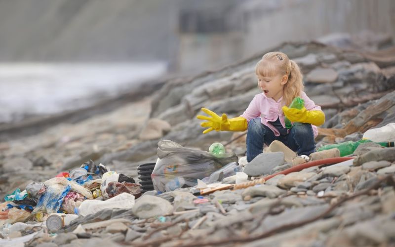 concrete-bins-little-girl-cleaning-beach-min
