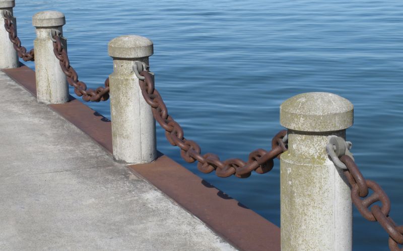 StreetScape - Concrete - Bollards - with - Chains - near - water-min